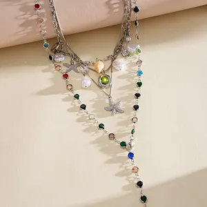 Detailed macro view of a layered silver necklace with starfish shell charms and pearls