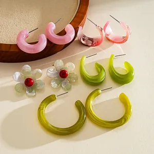 Detailed view of colorful resin earrings set featuring C-shape and flower designs