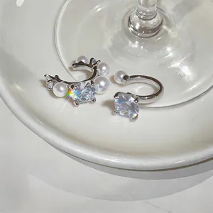 Detailed macro shot of elegant French-style zircon and pearl non-pierced ear cuffs.