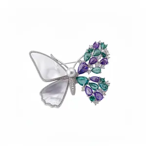 Elegant asymmetrical butterfly brooch with zircon stones, shell inlay and central pearl