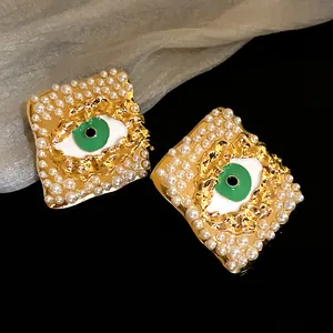 Exquisite vintage gold rhombus stud earrings with pearls and green evil eye detail
