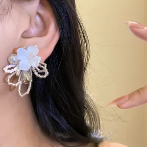 Close-up detail of exquisite white gardenia beaded flower stud earring for women