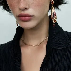 Exquisite vintage European palace style resin flower earrings with red crystals on model