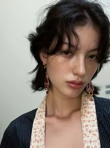 Close-up detail of vintage baroque style resin flower drop earrings on female model