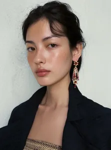 Close-up of vintage court style resin floral earrings worn by a model