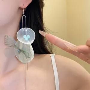 Detailed view of Mori style chiffon butterfly earrings with shell petals and long tassels.