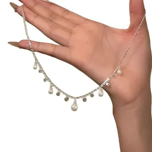 Elegant silver-tone necklace featuring dainty dangling pearls and sparkling zircon stones