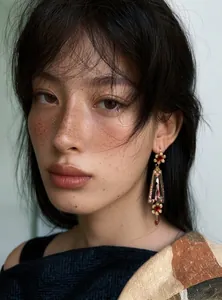 Detailed shot of vintage court style resin flower earrings on an Asian female model