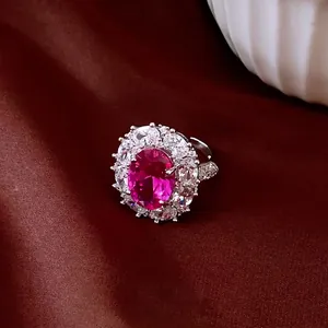 Elegant vintage royal style zircon flower open ring with central magenta oval gemstone.