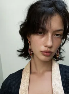 Close-up view of a fashion model wearing vintage palace style resin floral drop earrings