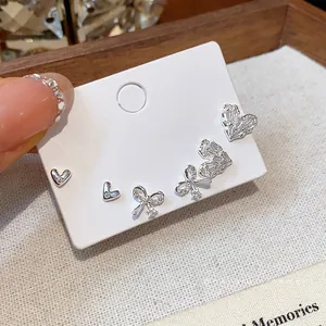 Elegant silver zircon stud earring set featuring heart and bow designs for women