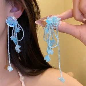 Elegant light blue floral tassel earrings with silver needles for a romantic holiday look.