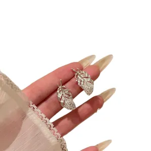 Elegant silver feather stud earrings with sparkling rhinestone accents for stylish women