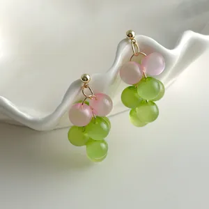 Detailed view of colorful translucent grape cluster earrings with delicate pink and green beads