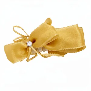 Elegant golden oversized ribbon bow banana hair clip for vertical ponytail hair styling