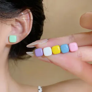 Detail view of colorful square oil-dripped stud earrings in various pastel shades