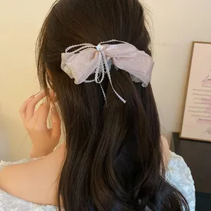 Elegant pink ribbon bow banana clip for sweet ponytail hairstyle on long wavy hair