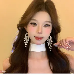 Elegant French palace style silver needle crystal tassel earrings worn by Asian model