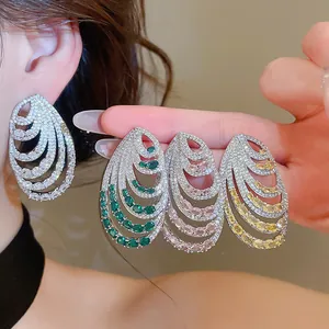 Detailed view showing multi-layer spiral zirconia earrings in four vibrant colors