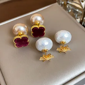 Detailed view of vintage flower and star pearl earrings with 18K gold plating