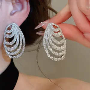 Detailed view of elegant multi-layered spiral teardrop earrings with shimmering zirconia