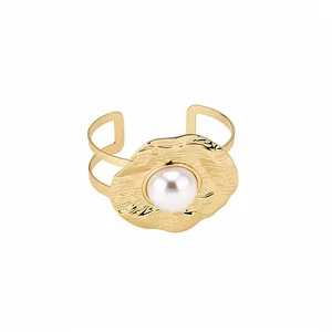 Vintage gold hammered texture open bangle with an elegant central pearl centerpiece design.