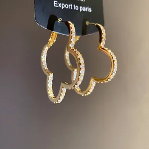 Elegant gold-plated clover hoop earrings encrusted with sparkling cubic zirconia.