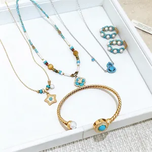 Elegant 18k gold plated jewelry set featuring pearl and turquoise necklaces and bracelet