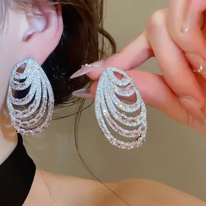 Detail of luxury multi-layer spiral earrings with pink and clear zircon crystals
