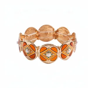 Retro gold-toned enamel elastic bracelet with orange circular segments and pearl accents