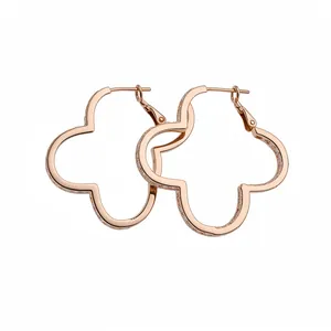 Elegant rose gold clover hoop earrings with shimmering zircon stones on white background