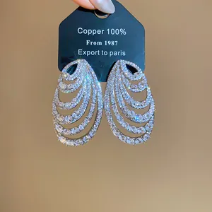 Detail of exquisite silver multi-layered spiral earrings with sparkling cubic zirconia stones