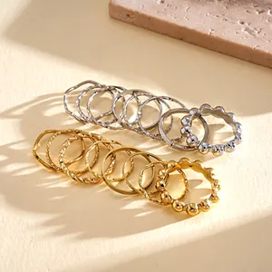 Detailed view of minimalist gold and silver metal ring set with various textures