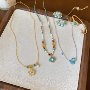 Elegant 18k gold plated jewelry set featuring pearl and turquoise necklaces.