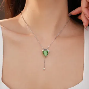Resin grape pendant necklace with pearls and flower, shown on model as a delicate choker