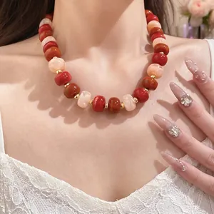 Handmade chunky geometric bead necklace with red and orange marble accents