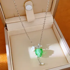 Detail of resin grape pendant necklace with dainty white flower and pearl charms