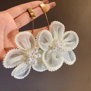 Elegant silver needle drop earrings featuring white mesh flowers and pearl clusters