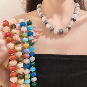 Detail of handmade colorful geometric beaded necklace showing vibrant multi-color beads