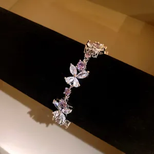Detailed close-up view of an elegant silver zircon flower bracelet with purple stones