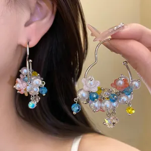 Detail view of sweet pearl flower dangle hoop earrings with colorful crystal beads