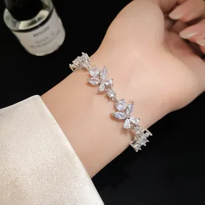 Close-up of elegant floral cubic zirconia bracelet with silver finish on female wrist