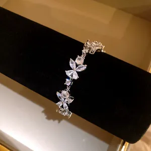 Silver floral bracelet with sparkling zircon flower petals on black velvet