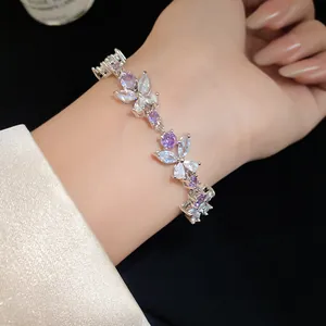 Close-up detail of a French style silver flower bracelet with purple and white zircons.