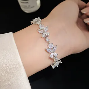 Close-up of an elegant silver flower bracelet with sparkling zircons on a person's wrist