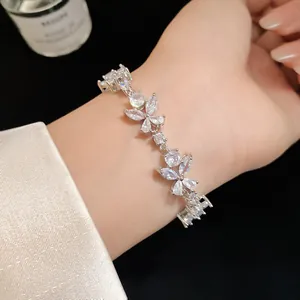 Close-up of sparkling cubic zirconia flower bracelet on woman's wrist, luxury jewelry detail.