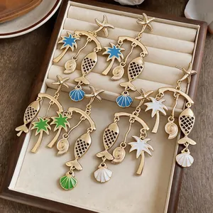 Tropical fish and palm tree gold enamel drop earrings for a summer beach vacation
