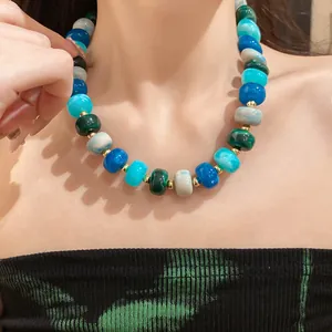 Detail of a handmade multi-color geometric beaded necklace for women in niche style