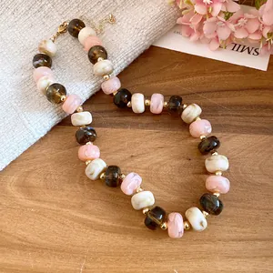 Close-up of handmade chunky necklace featuring multi-colored marble-textured beads