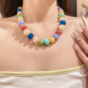 Detailed view showing the vibrant handmade colorful beaded geometric necklace on a model